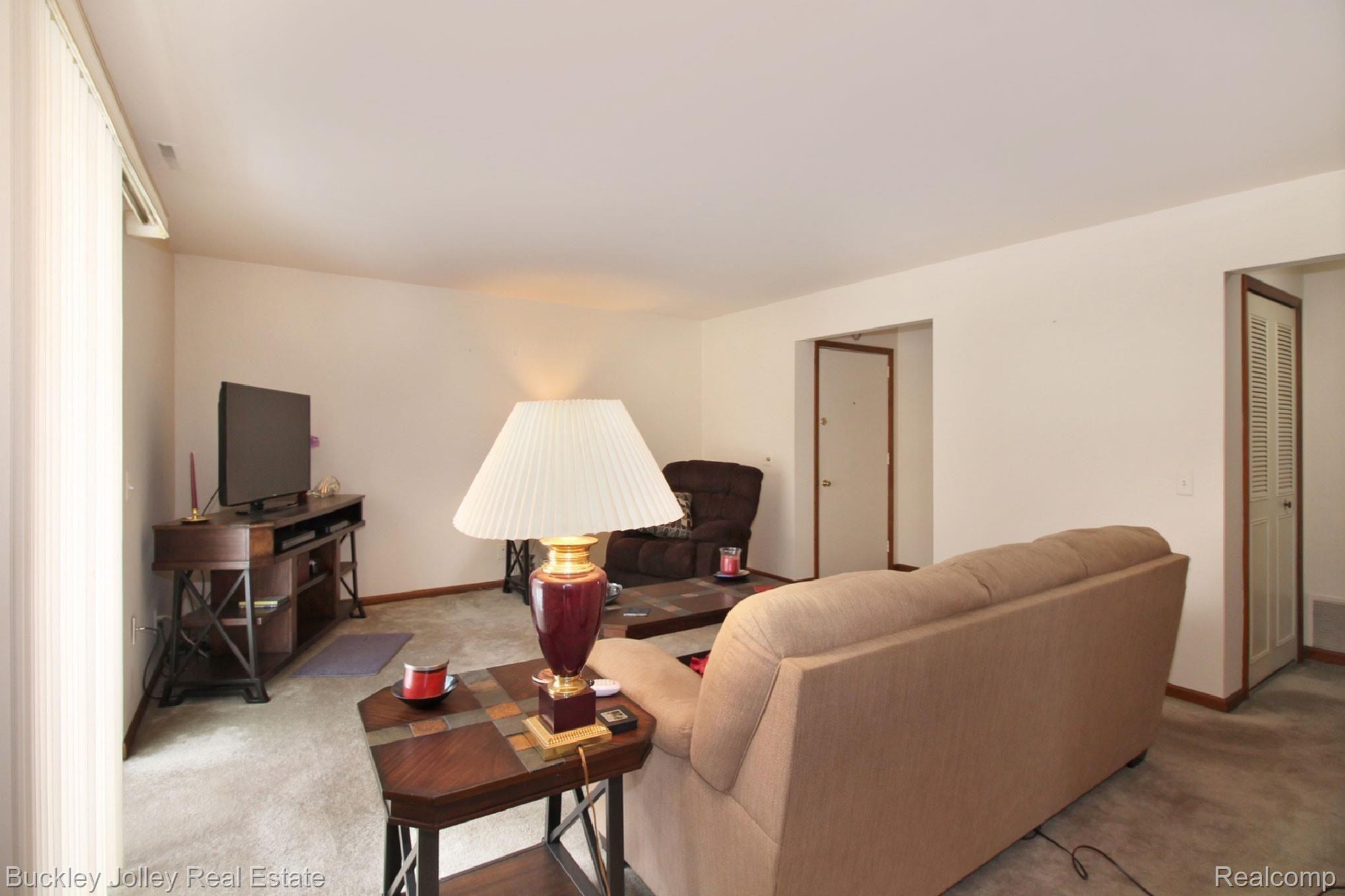 515 West Highland Road, Unit E10 Howell, MI 48843 - Photo 7 of 17 14x18 Living Room.jpg