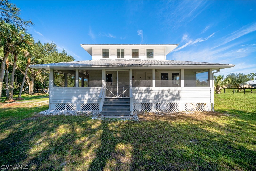 2071 Balsey Road Alva, FL 33920 - Photo 3 of 34 a front view of a house with a yard table and chairs