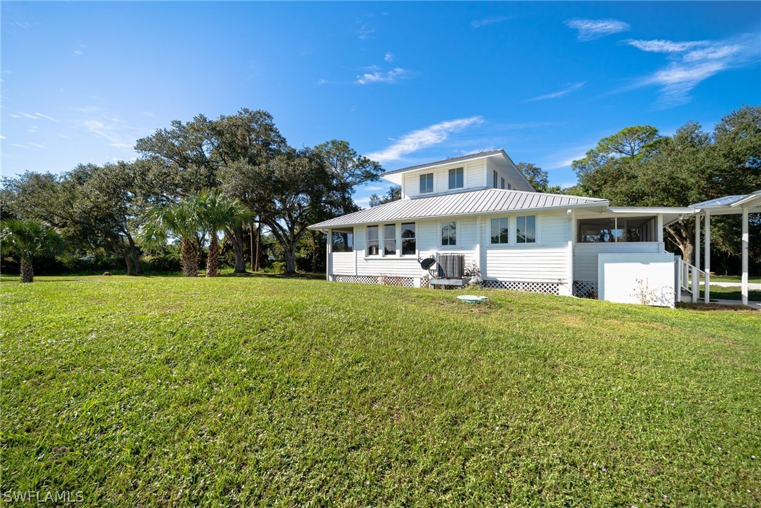 2071 Balsey Road Alva, FL 33920 - Photo 6 of 34 a view of a house with a backyard porch and sitting area