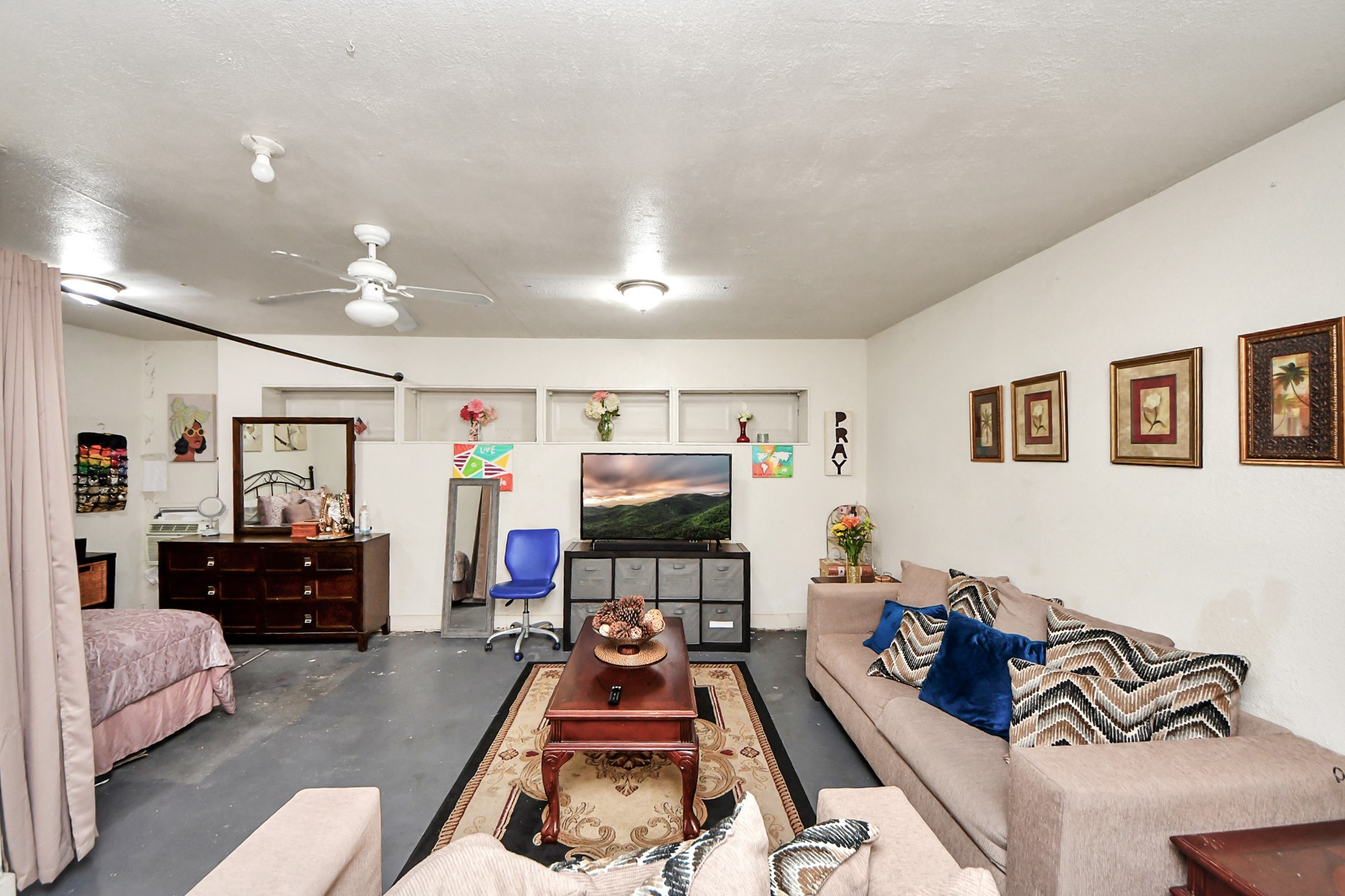 4155 Amir Street Houston, TX 77072 - Photo 25 of 43 a living room with furniture and a flat screen tv