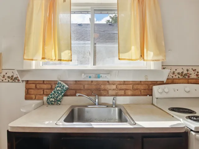 a kitchen with a sink and a refrigerator