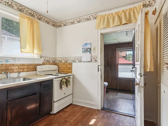 a bathroom with a sink a toilet and a window