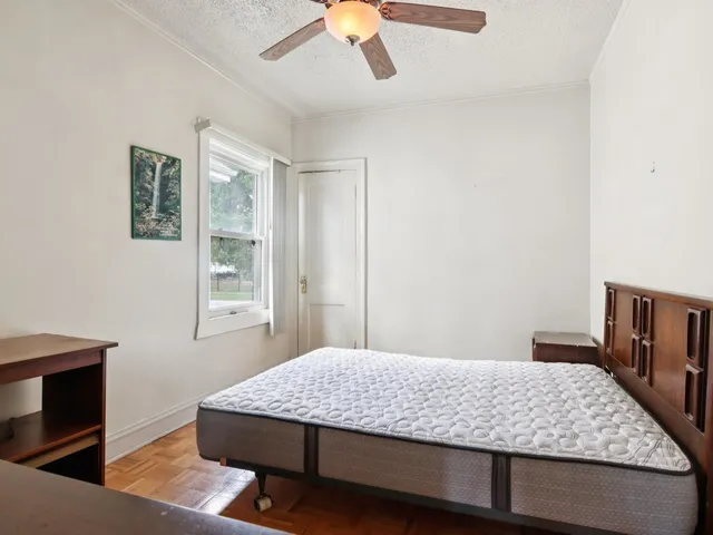 a living room with a furniture and a ceiling fan