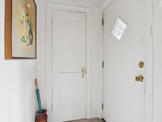 an empty room with windows and closet