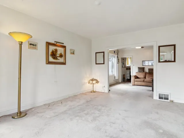 a living room with furniture and a ceiling fan