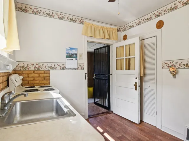 a kitchen with a sink a refrigerator and a stove