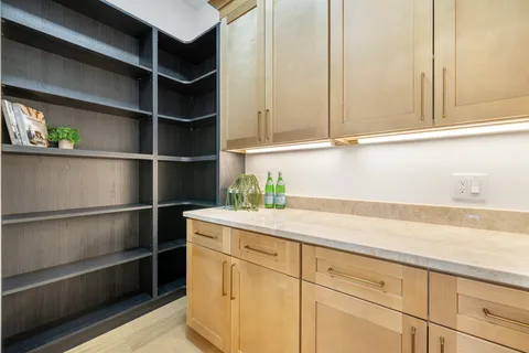 a bedroom with a bed mirror and window