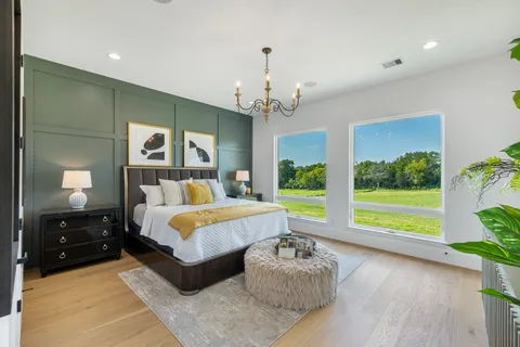 a spacious bathroom with a tub sink shower and mirror