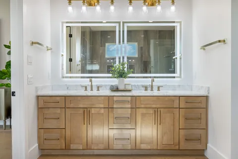 a bathroom with a granite countertop sink a toilet and shower