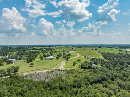 a living room with fireplace furniture and a large window