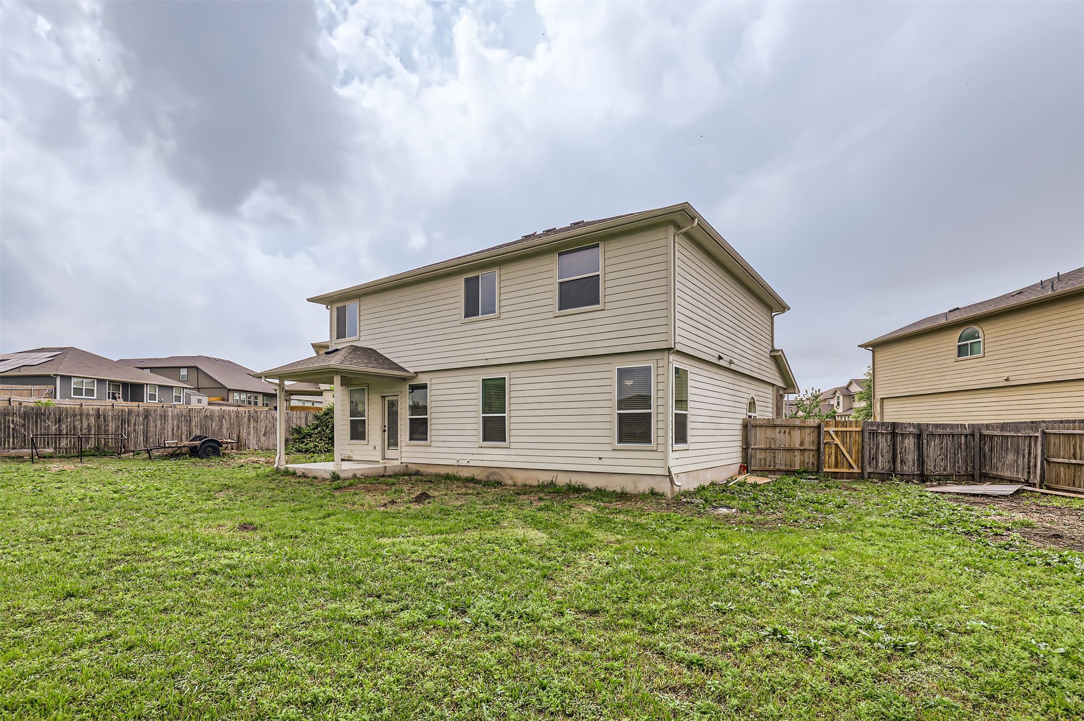 131 Lavaca Loop Hutto, TX 78634 - Photo 26 of 29 A well-maintained lawn and sturdy privacy fence enclose this inviting backyard space.