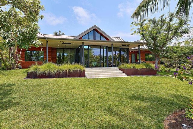 a view of a patio with table and chairs and potted plants