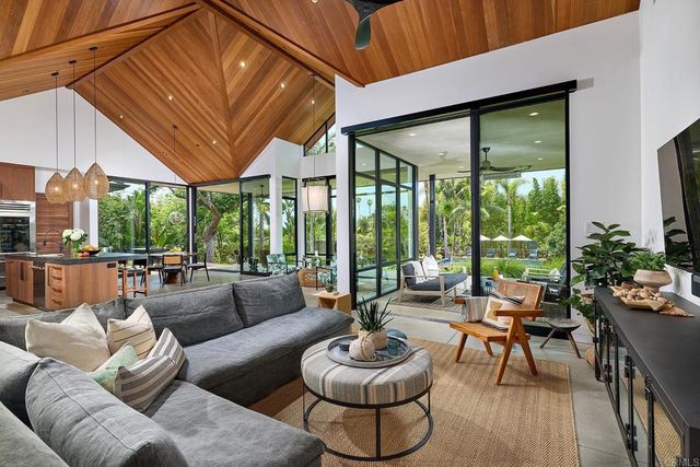 a kitchen with stainless steel appliances granite countertop a sink a stove and a wooden cabinets