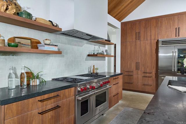 a view of a hallway with wooden shelves