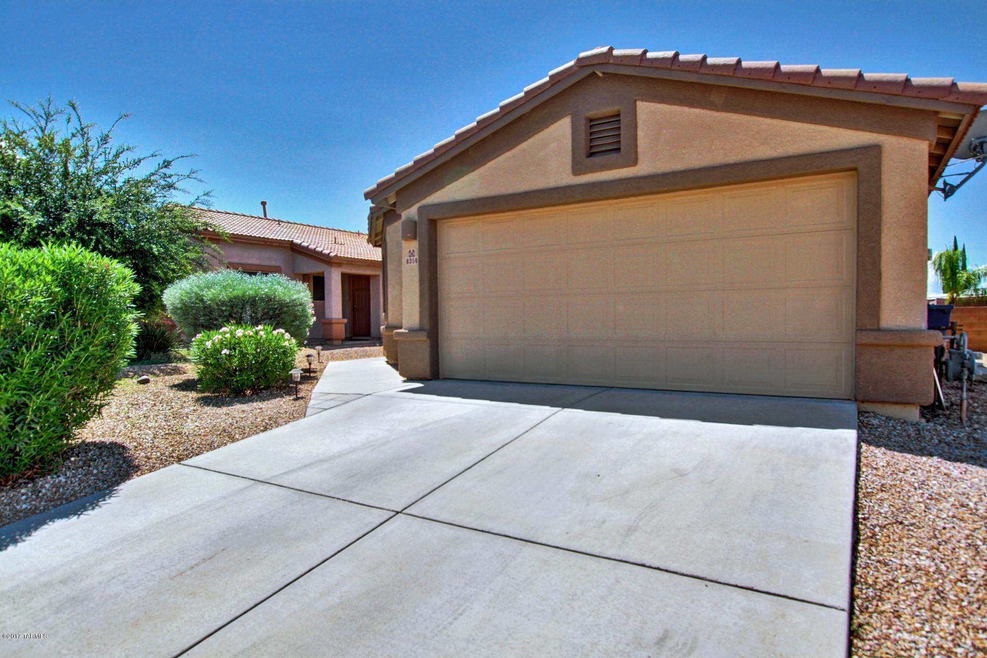 8350 East Bowline Road Tucson, AZ 85710 - Photo 3 of 26 a front view of a house with a yard