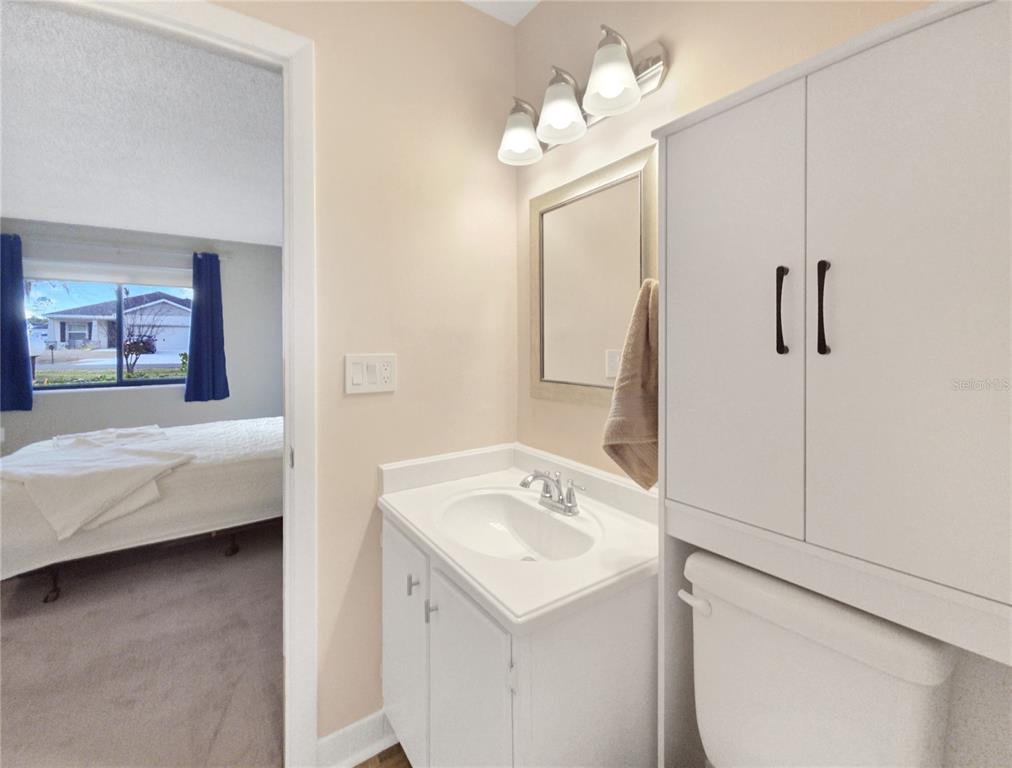 504 Silver Drive, Unit A Ocala, FL 34472 - Photo 13 of 28 a en suite bathroom with a sink and a mirror