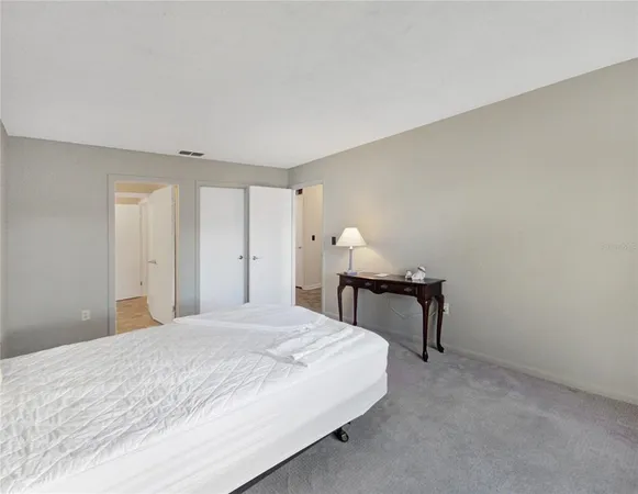 a bedroom with a bed and a table in it