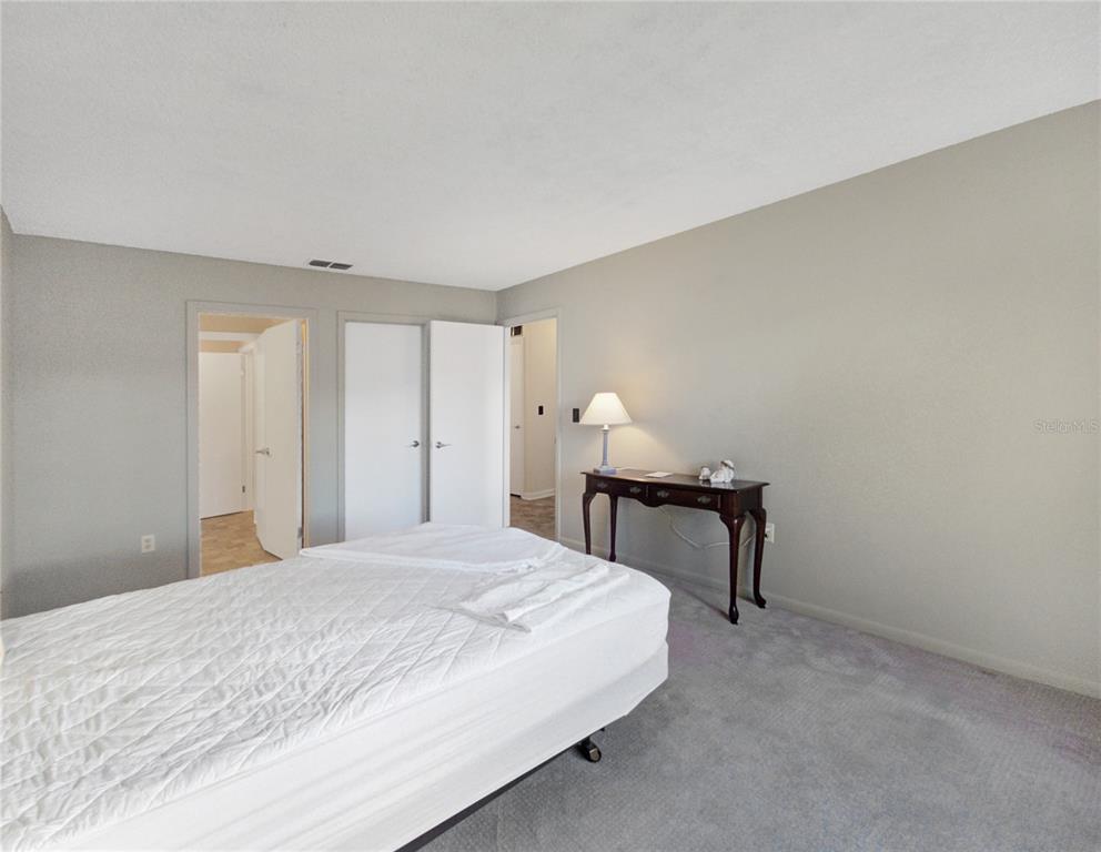 504 Silver Drive, Unit A Ocala, FL 34472 - Photo 15 of 28 a bedroom with a bed and a table in it