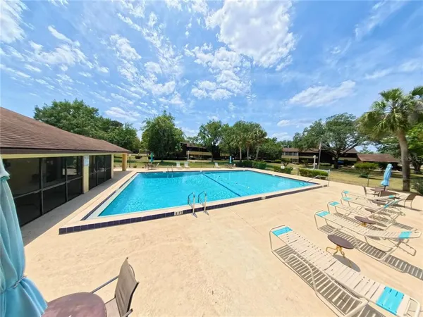a view of a swimming pool with an outdoor seating