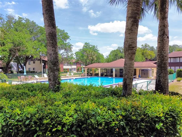 a view of a house with a yard and sitting area