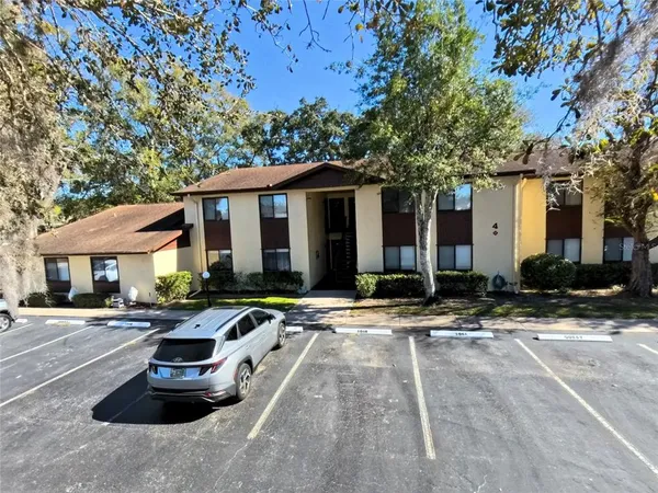 a front view of a house with yard and trees