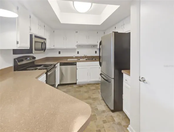 a kitchen with cabinets and stainless steel appliances