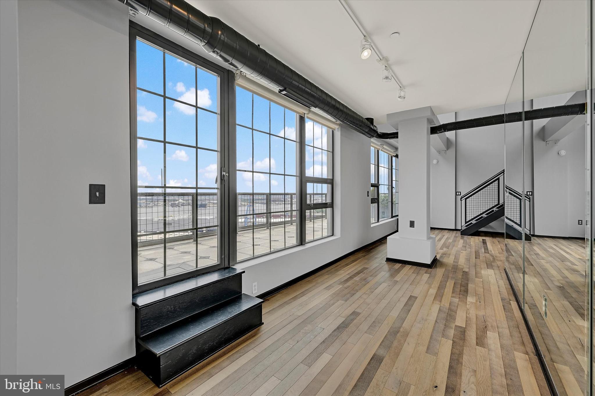 1200 Steuart Street, Unit 1913 Baltimore, MD 21230 - Photo 13 of 94 Walls of windows & Patapsco views.