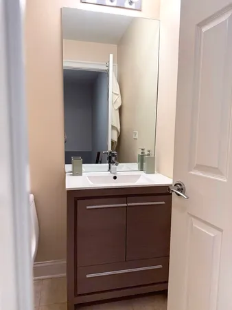 a white toilet sitting next to a bath tub
