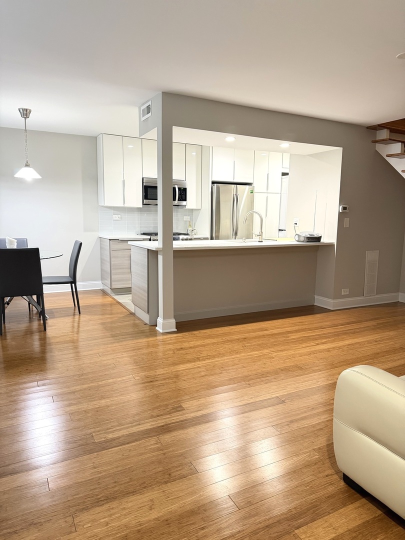 618 East Old Willow Road, Unit 183B Prospect Heights, IL 60070 - Photo 2 of 20 a living room with hard wood floors and kitchen view