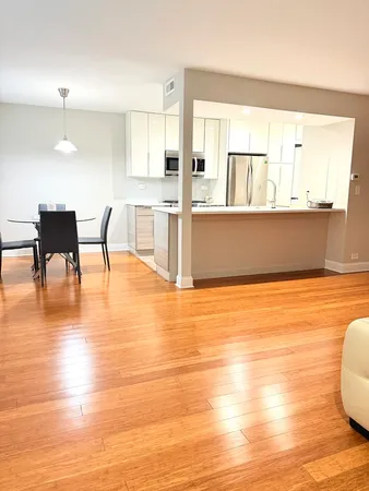 a view of a kitchen with kitchen island and a wooden floor