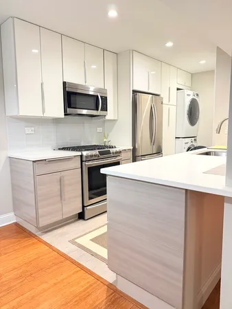 a kitchen with stainless steel appliances a stove a sink and a microwave