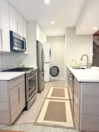 a kitchen with a sink stove and microwave