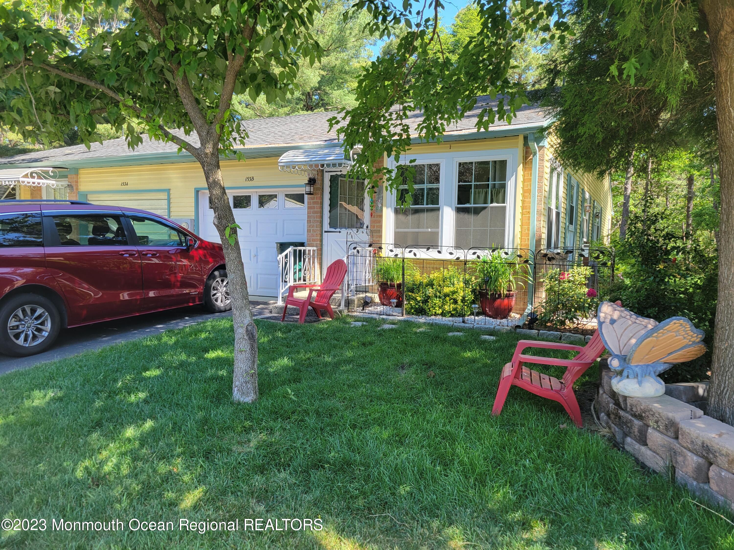 153 B Sunset Road, Unit 60 Manchester Township, NJ 08759 - Photo 1 of 15 a front view of a house with garden