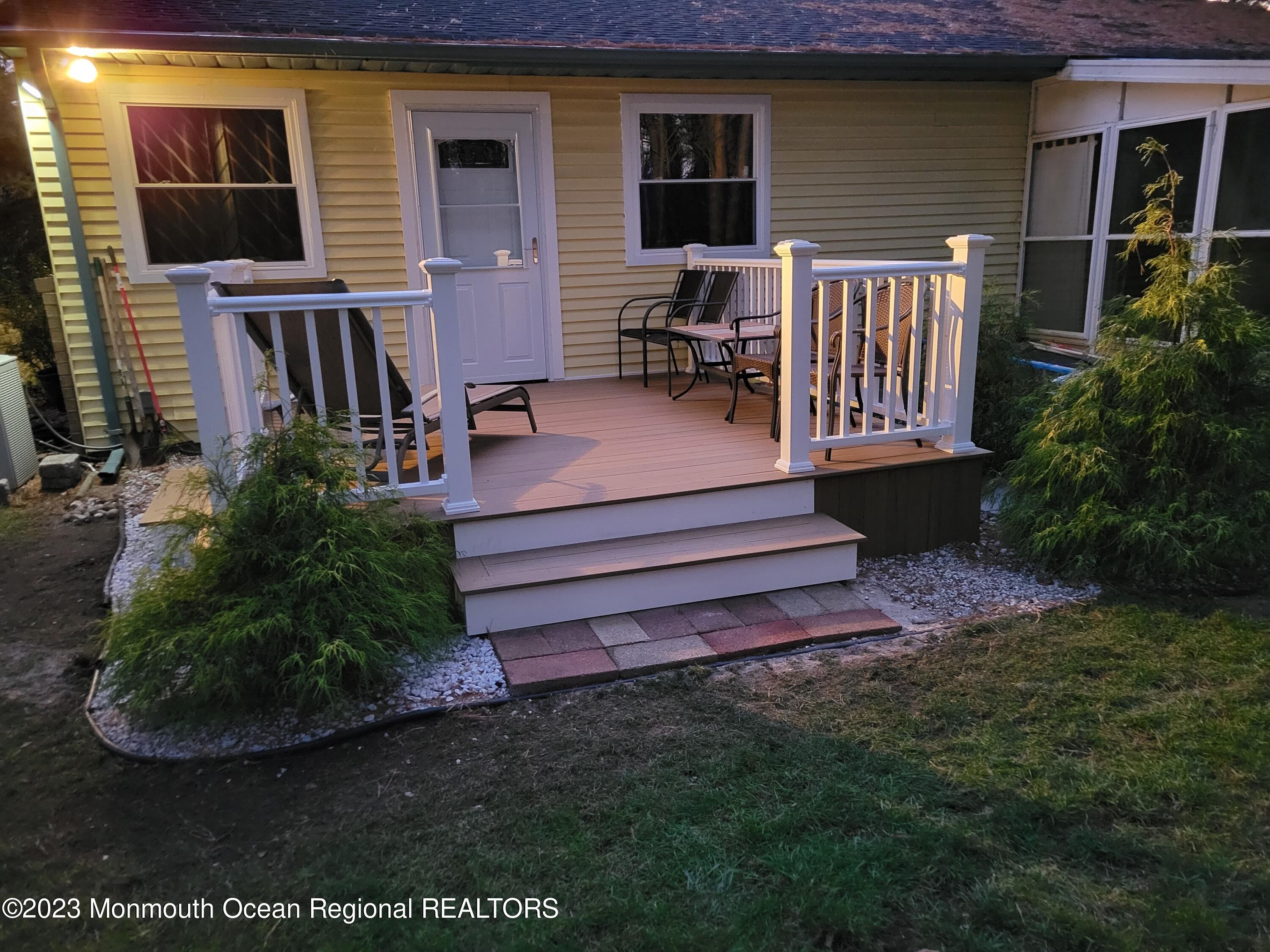 153 B Sunset Road, Unit 60 Manchester Township, NJ 08759 - Photo 3 of 15 a view of backyard with deck and outdoor seating