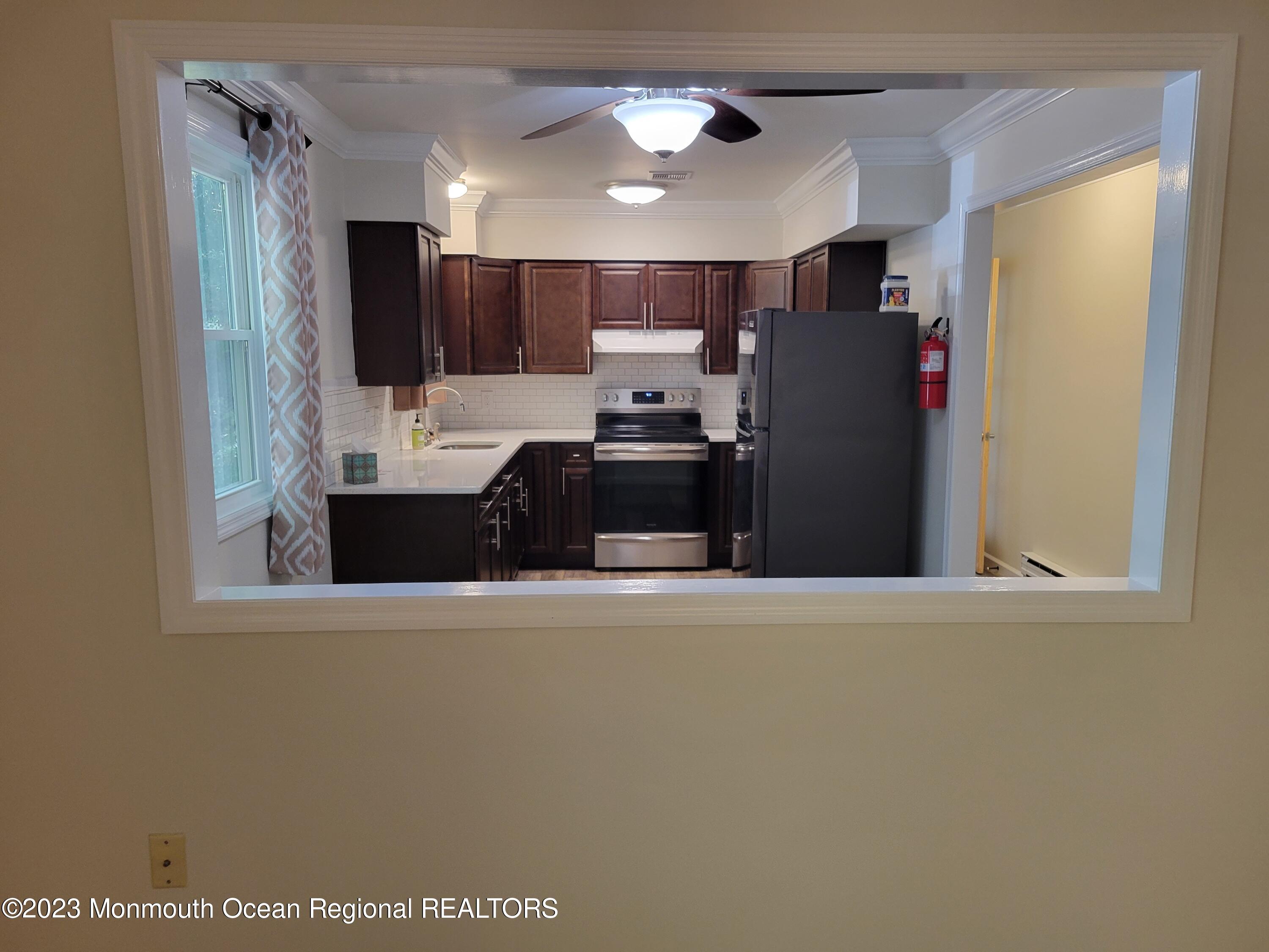 153 B Sunset Road, Unit 60 Manchester Township, NJ 08759 - Photo 4 of 15 a kitchen with stainless steel appliances a refrigerator and a sink