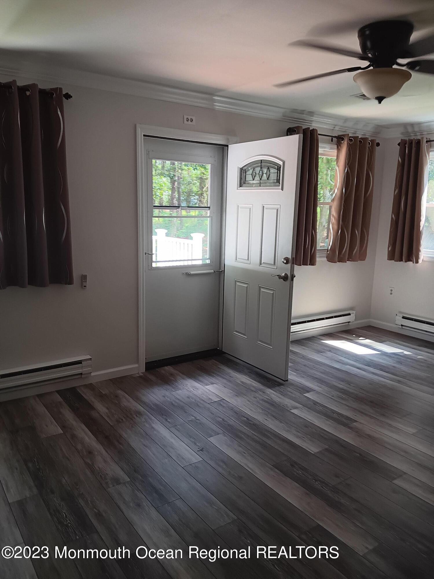 153 B Sunset Road, Unit 60 Manchester Township, NJ 08759 - Photo 8 of 15 an empty room with windows