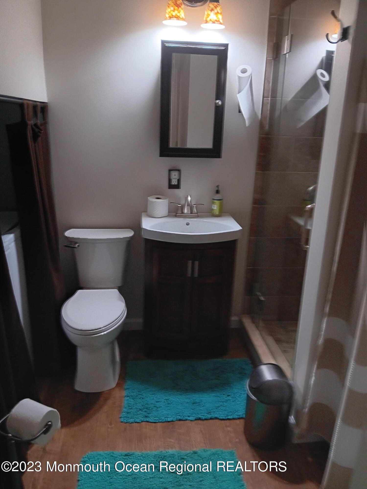 153 B Sunset Road, Unit 60 Manchester Township, NJ 08759 - Photo 9 of 15 a bathroom with a toilet and a sink