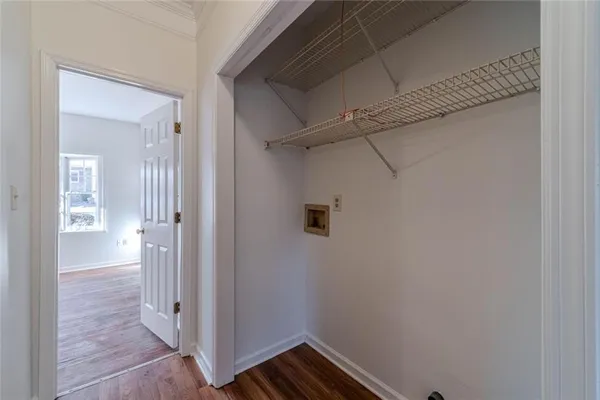 an empty room with wooden floor chandelier fan and windows