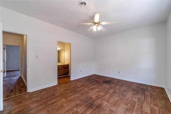 a view of an empty room with closet and a chandelier fan