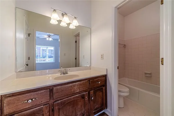 a bathroom with a sink a light fixture and a mirror