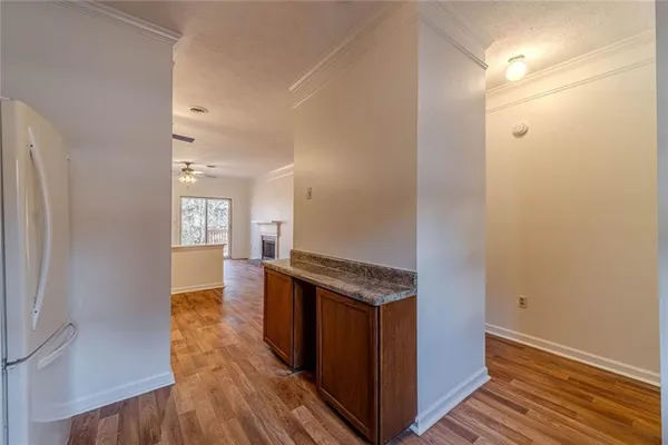 a kitchen with stainless steel appliances granite countertop wooden cabinets a sink and dishwasher with wooden floor