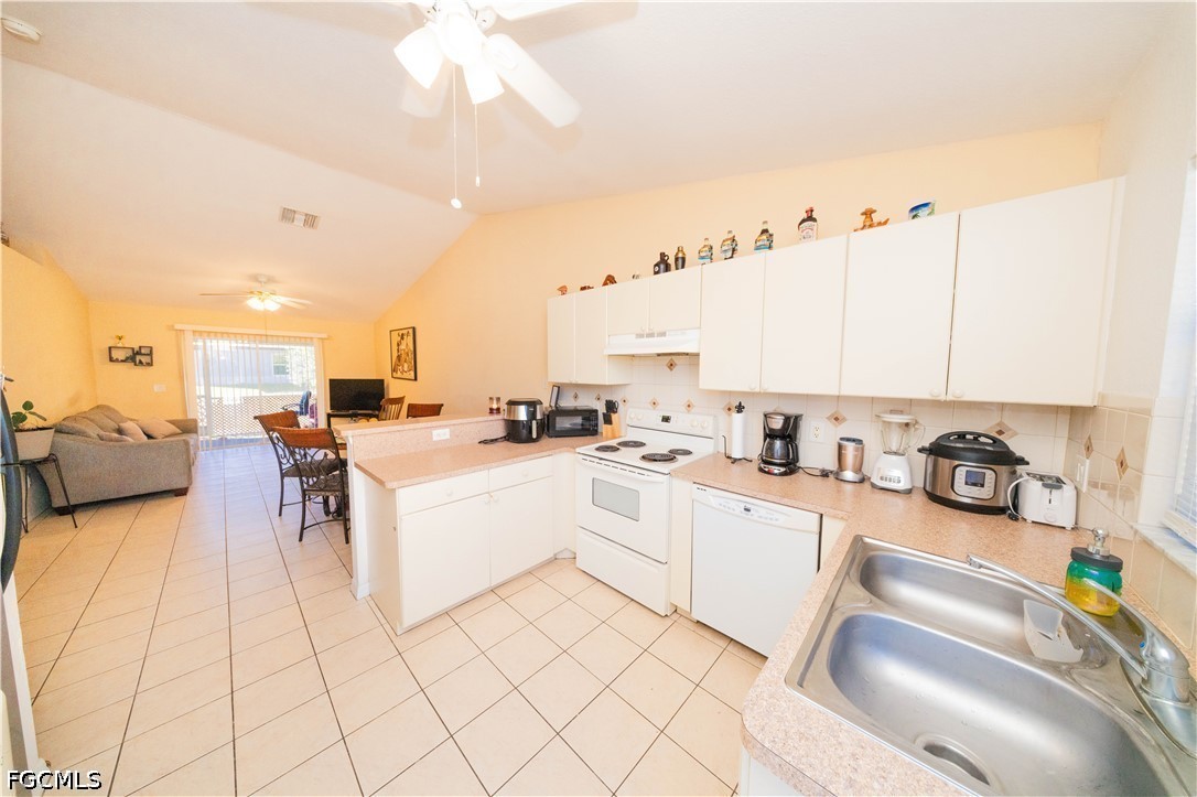 4519 25th Street Southwest Lehigh Acres, FL 33973 - Photo 20 of 24 a large white kitchen with cabinets