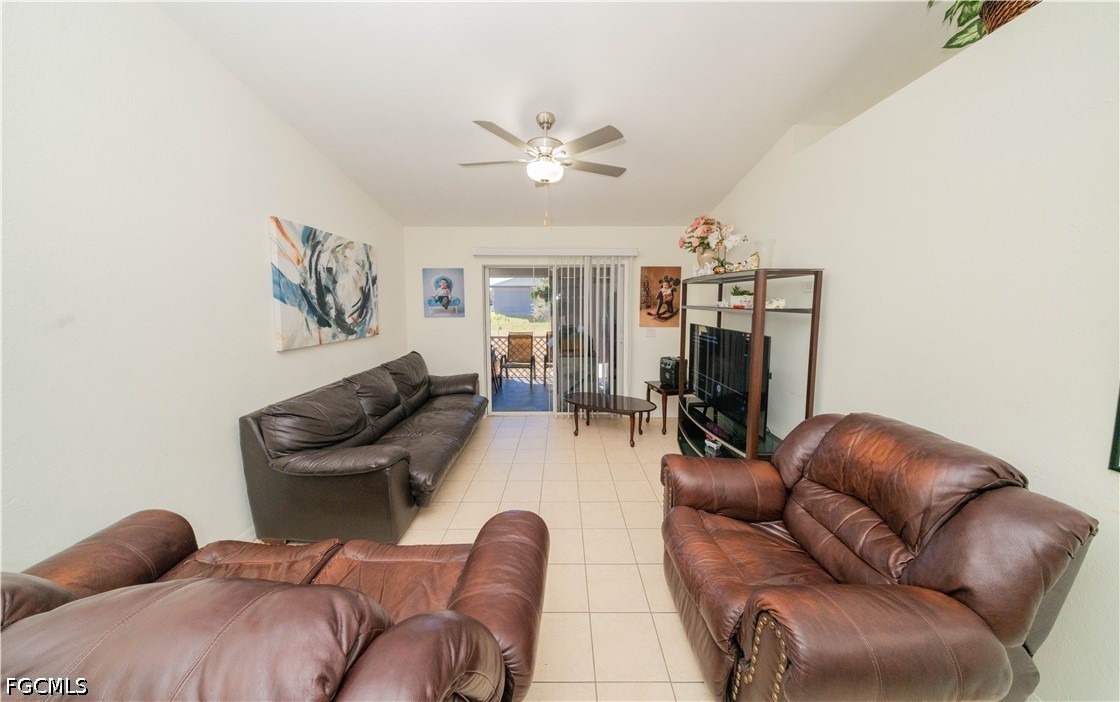 4519 25th Street Southwest Lehigh Acres, FL 33973 - Photo 2 of 24 a living room with furniture and a chandelier
