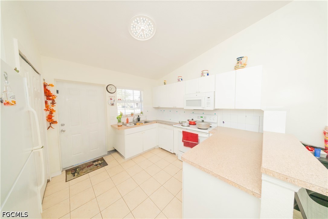 4519 25th Street Southwest Lehigh Acres, FL 33973 - Photo 5 of 24 a bedroom with a bed and cabinets