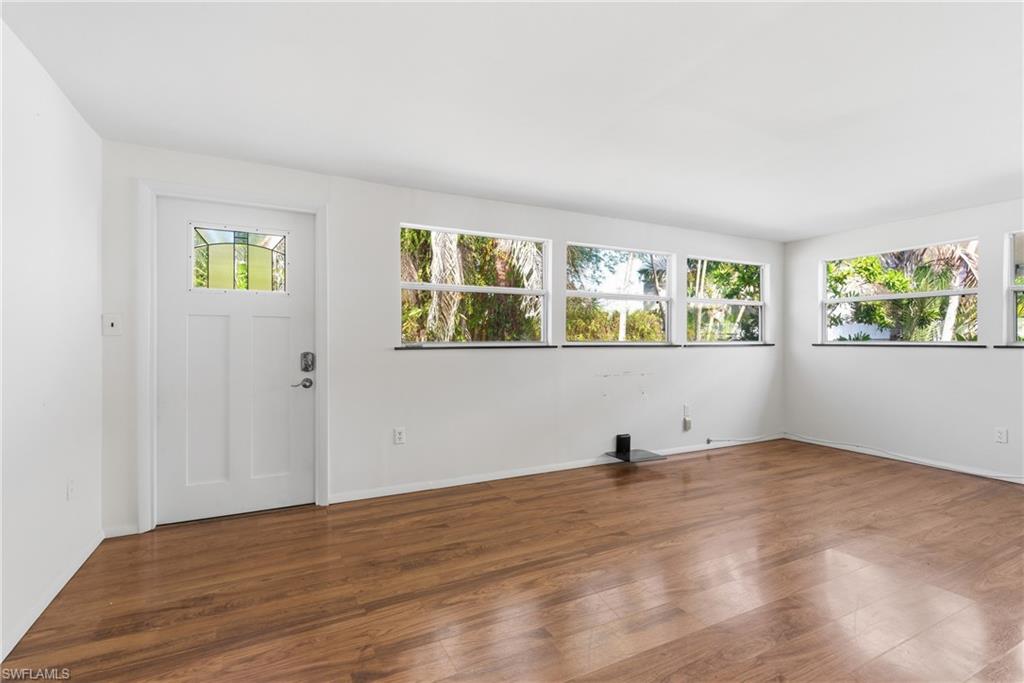 1235 Rordon Avenue Naples, FL 34103 - Photo 14 of 50 wooden floor in an empty room with a window