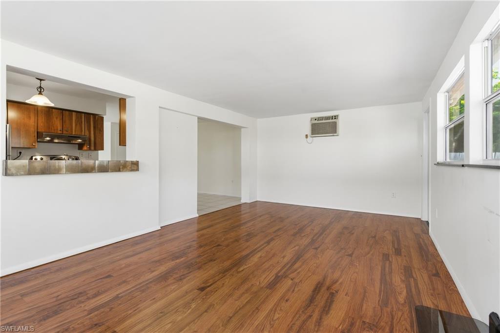 1235 Rordon Avenue Naples, FL 34103 - Photo 16 of 50 a view of a livingroom with wooden floor and a flat screen tv