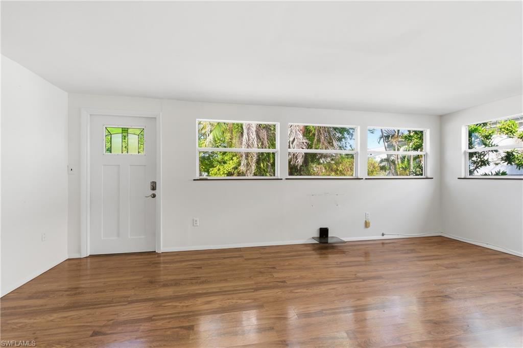 1235 Rordon Avenue Naples, FL 34103 - Photo 18 of 50 a view of room with window and wooden floor