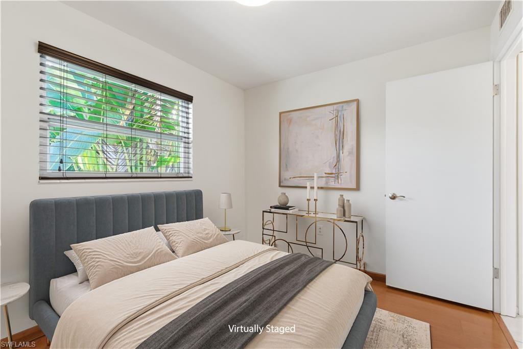 1235 Rordon Avenue Naples, FL 34103 - Photo 20 of 50 a bedroom with a bed and wooden floor