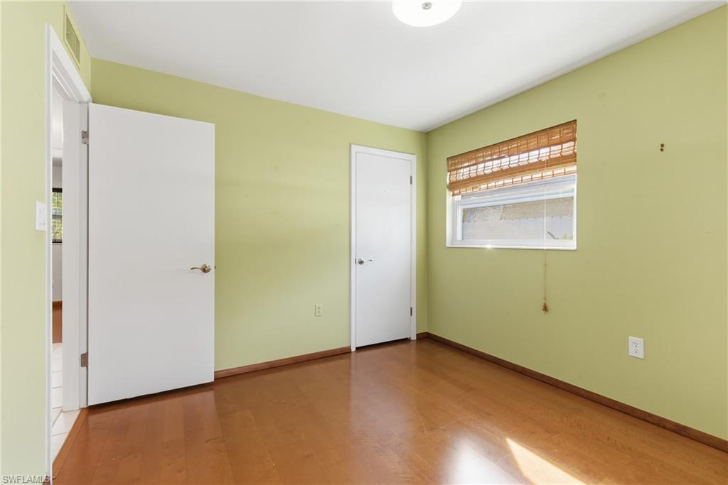1235 Rordon Avenue Naples, FL 34103 - Photo 32 of 50 a view of an empty room with wooden floor and a window