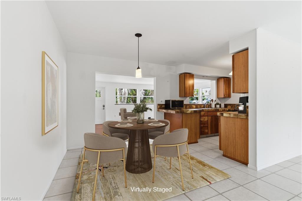 1235 Rordon Avenue Naples, FL 34103 - Photo 6 of 50 a living room with couches a dining table and chairs with kitchen view